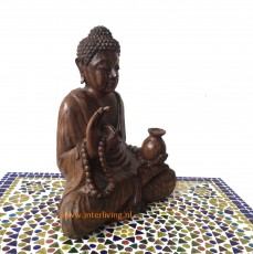 mediterend boeddha beeld van hout betekenis